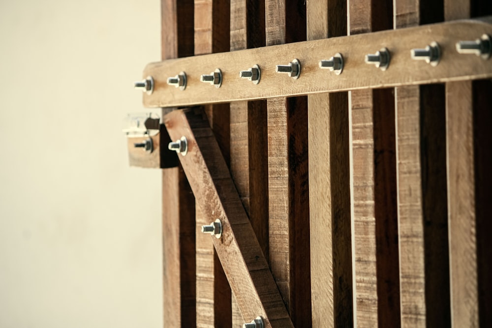 a close up of a wooden door with metal handles