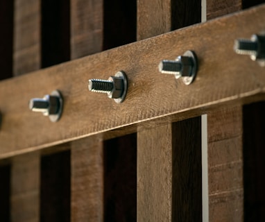 a close up of a wooden fence with screws