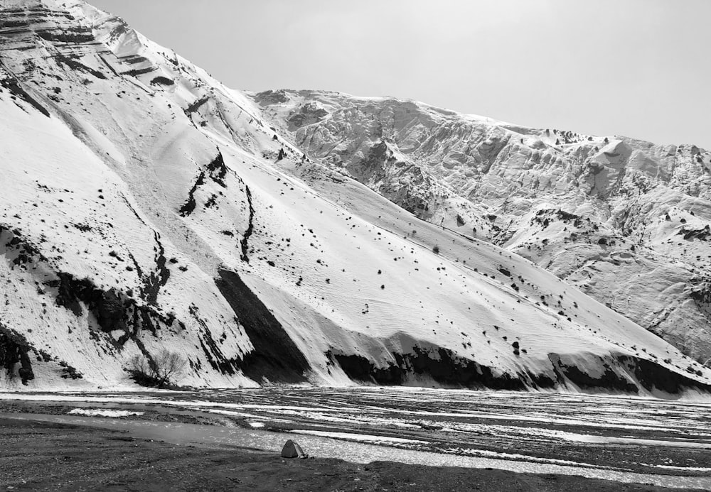 a black and white photo of snow covered mountains