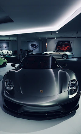 A sleek black sports car illuminated under moody lighting, reflecting the premium automotive vibe.