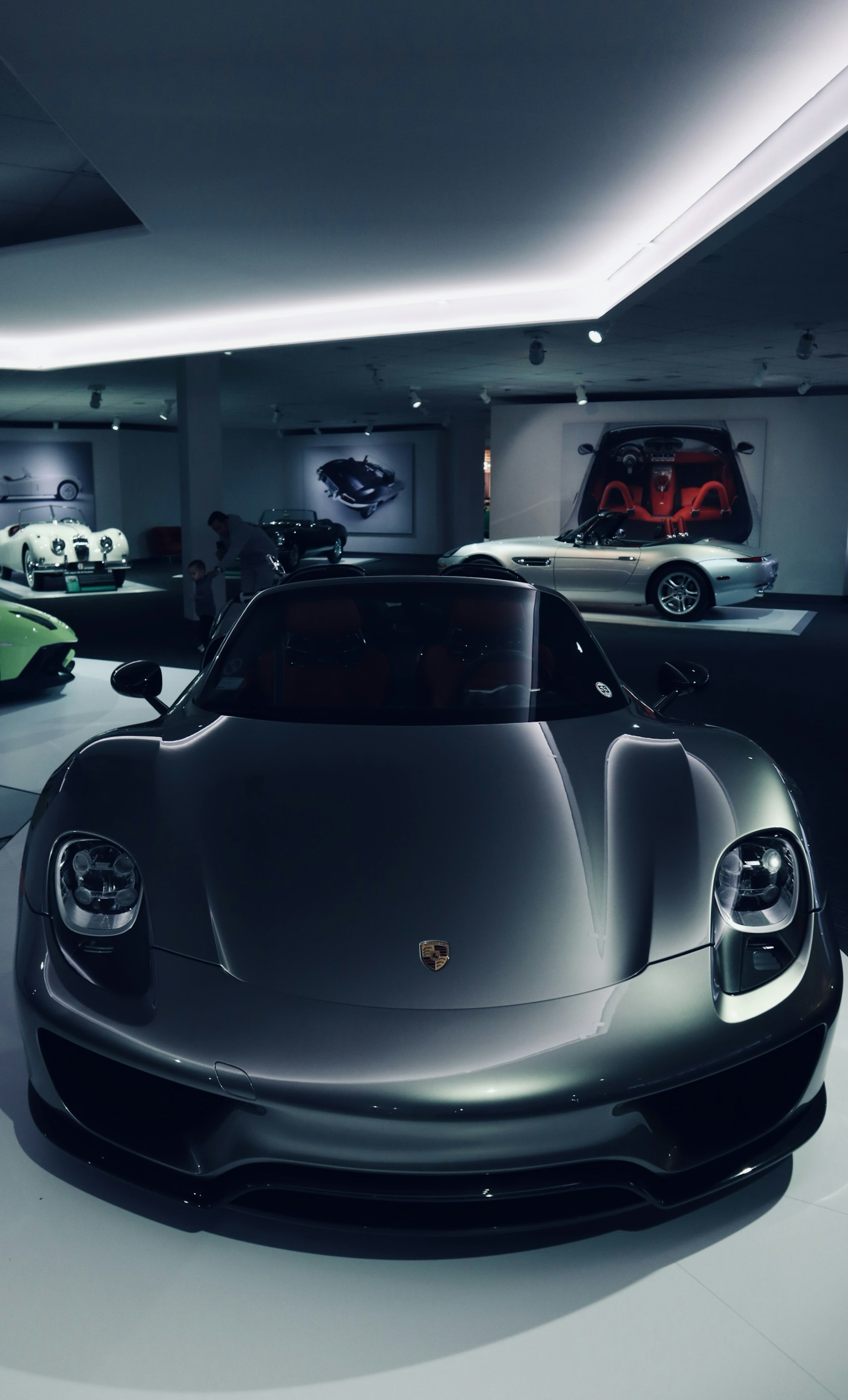 A sleek, polished sports car gleaming under showroom lights, highlighting its aerodynamic curves.