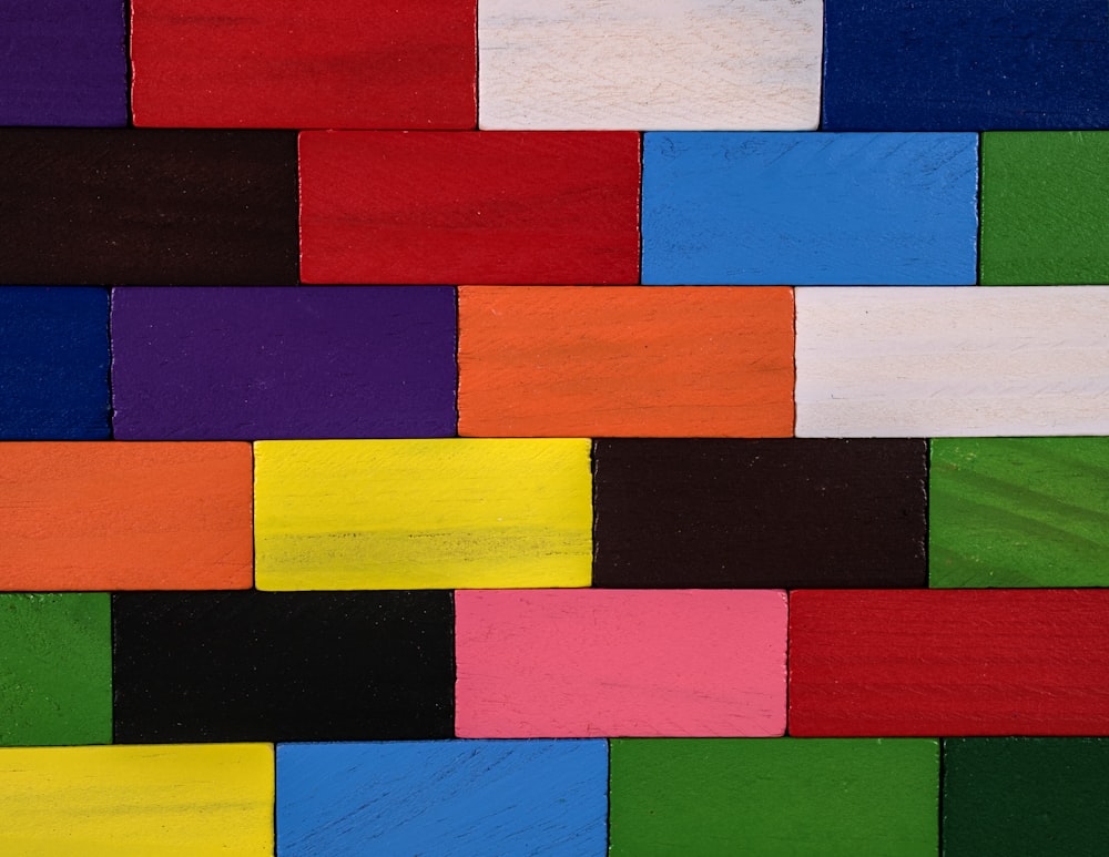 a close up of a multicolored wall made of wood