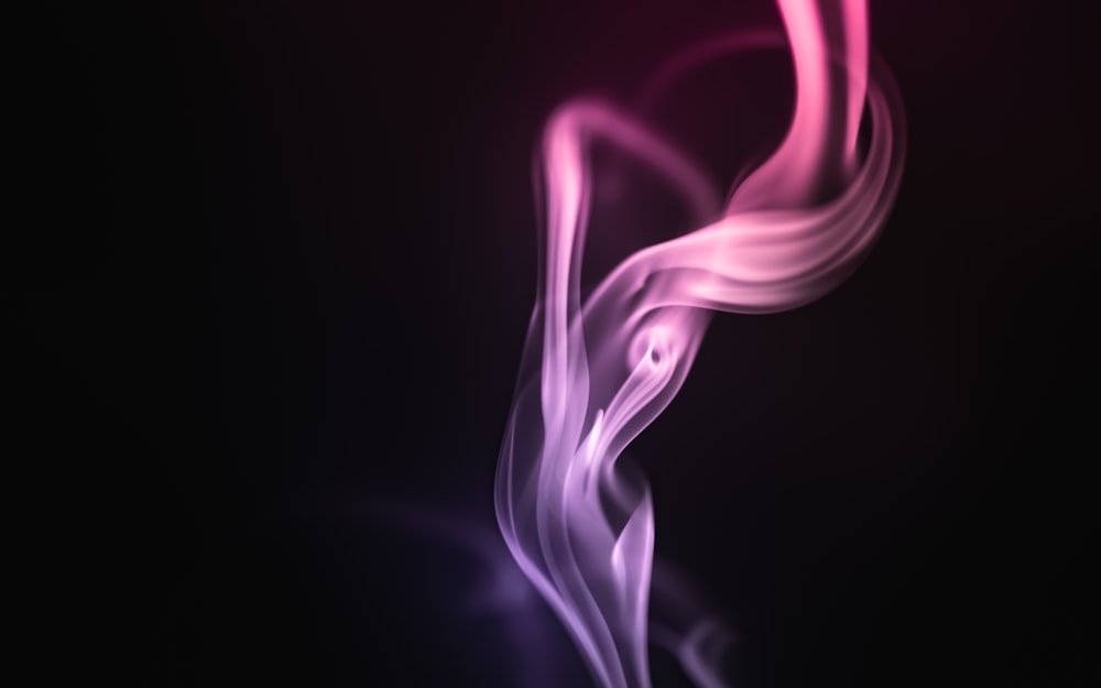 a pink and purple smoke swirl on a black background