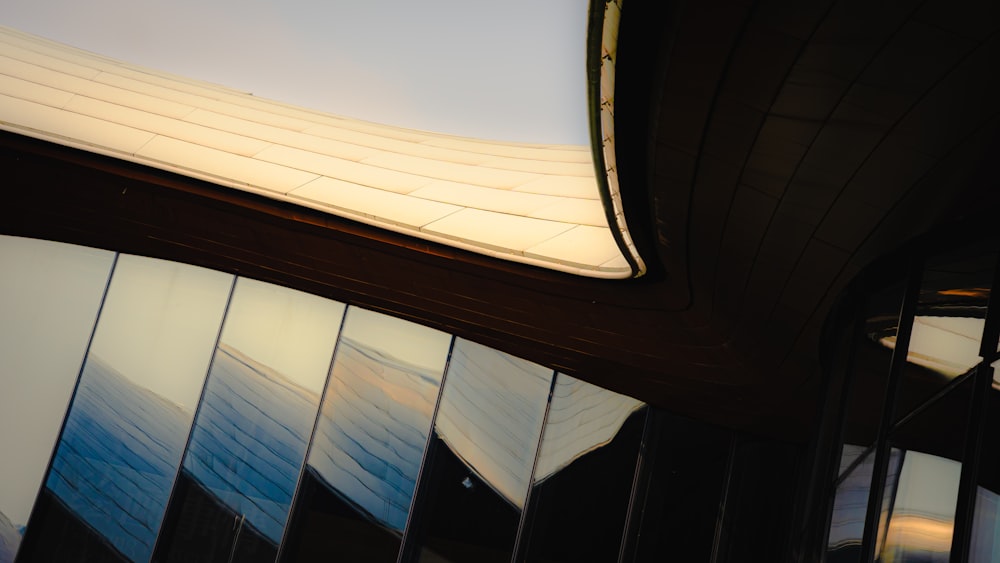 a building with a curved roof and glass windows