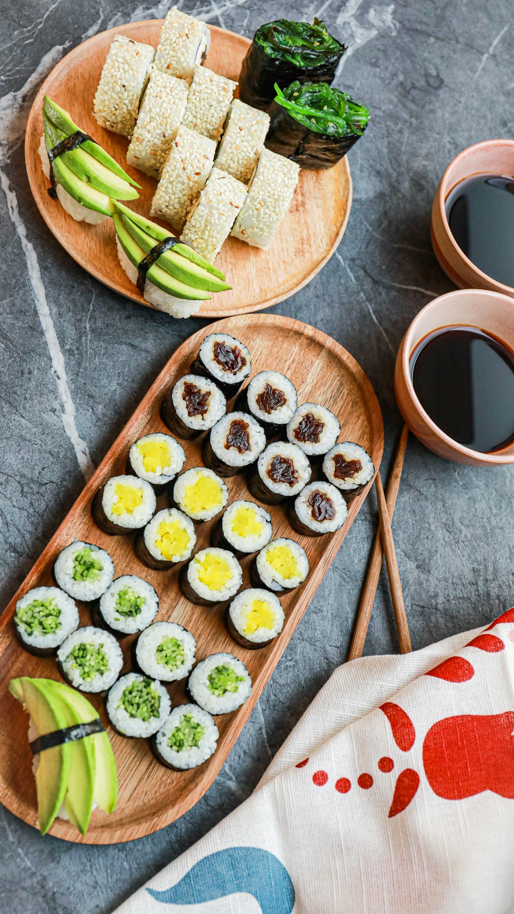 a table topped with plates of sushi and chopsticks