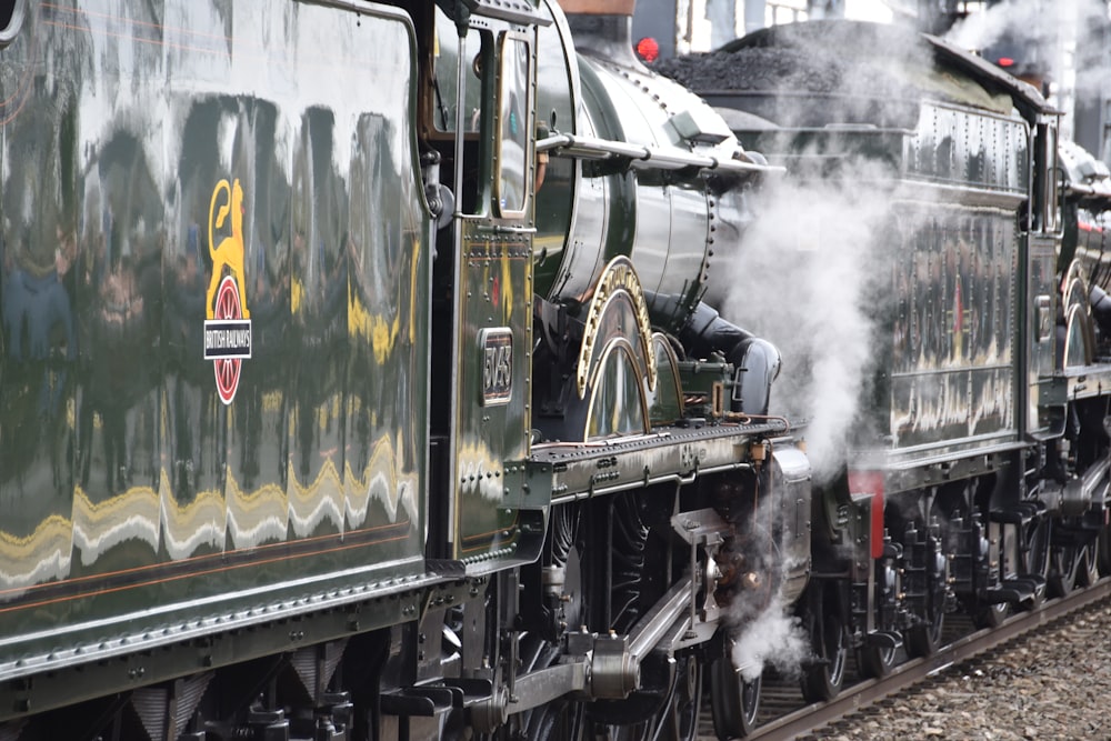 a steam engine train traveling down train tracks