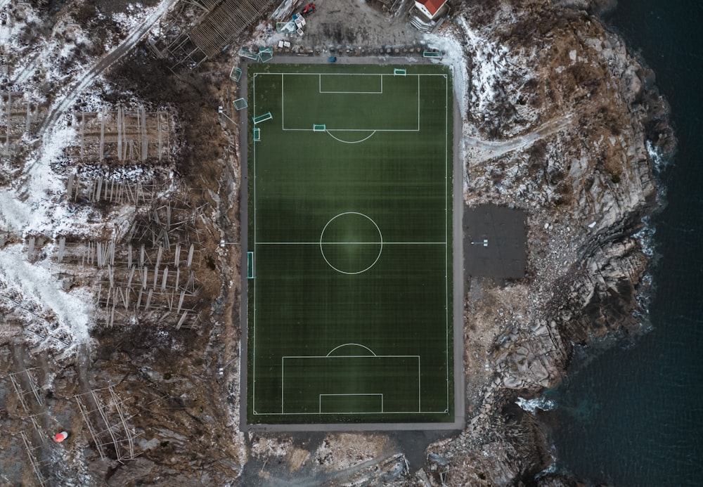 an aerial view of a soccer field in the snow