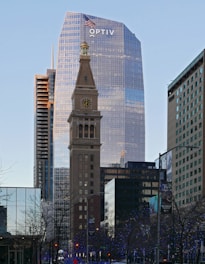 a tall clock tower towering over a city filled with tall buildings