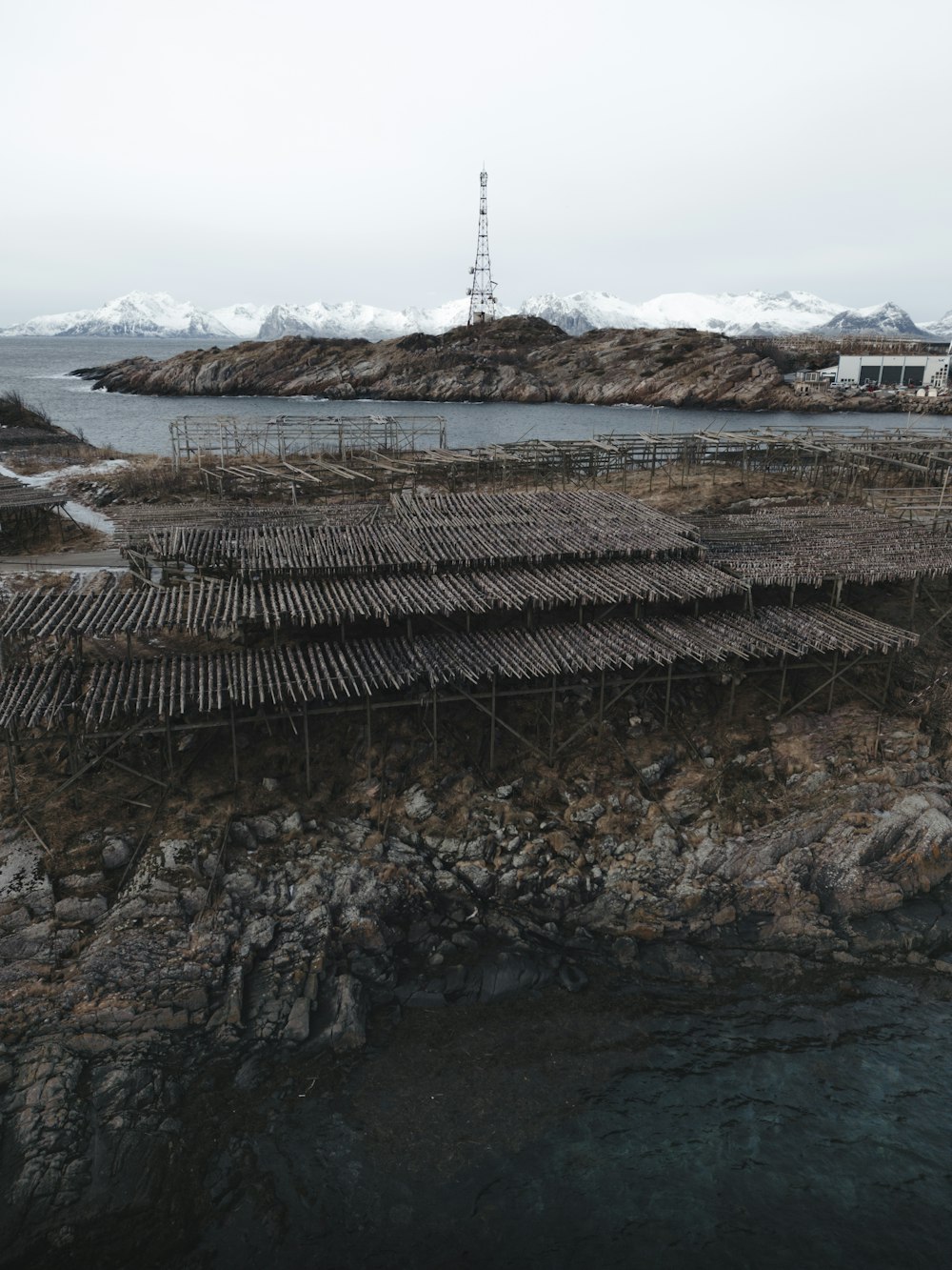 a group of wooden rafts sitting on top of a rocky shore