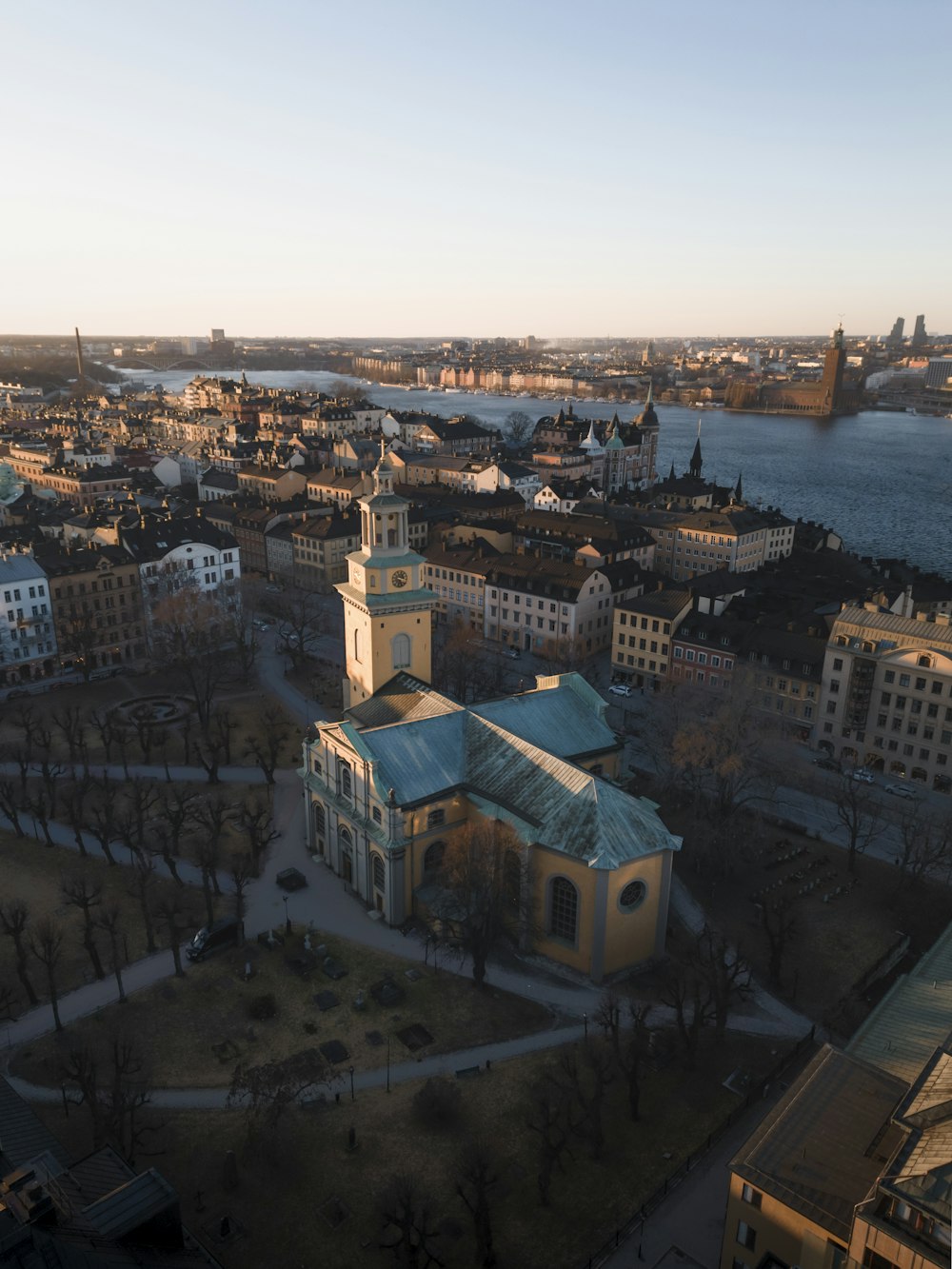 an aerial view of a city with a river in the background