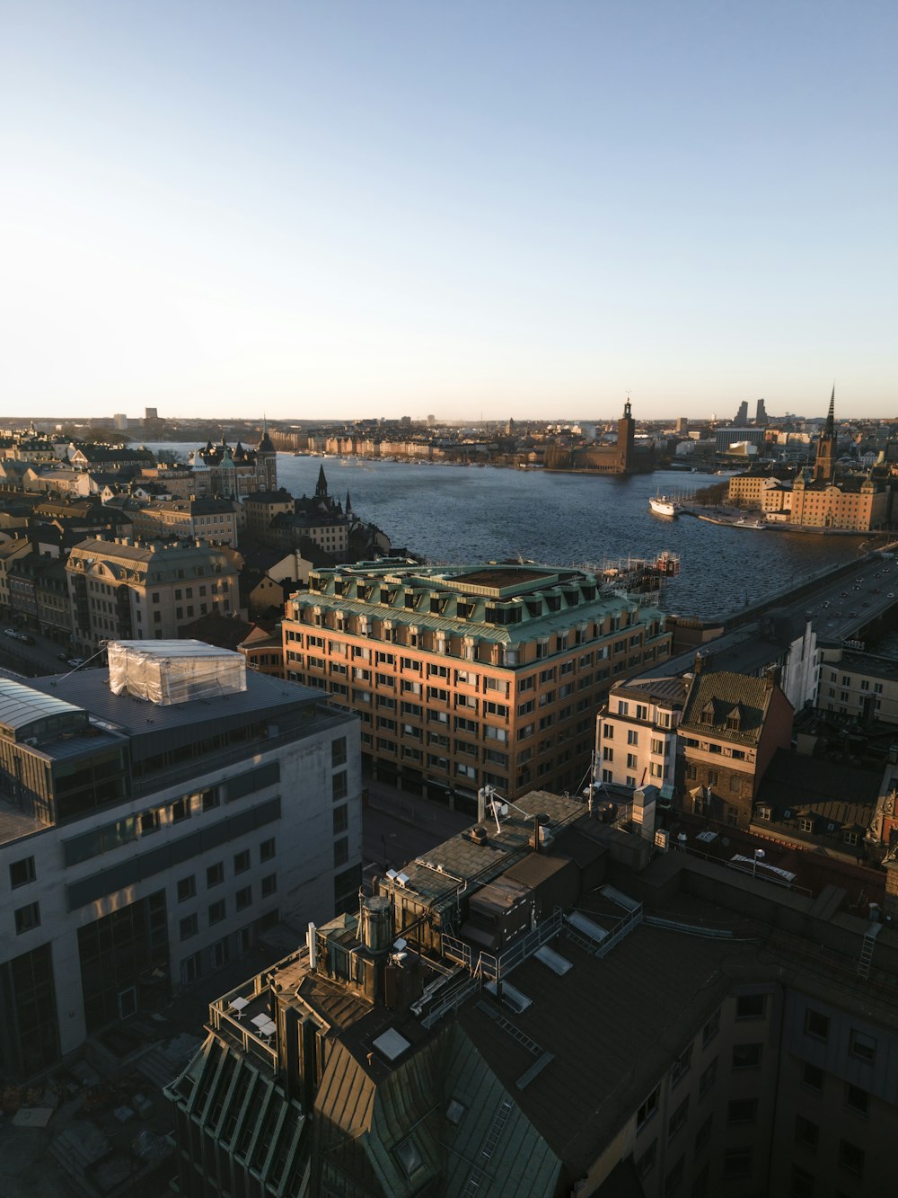 an aerial view of a city with a body of water in the background