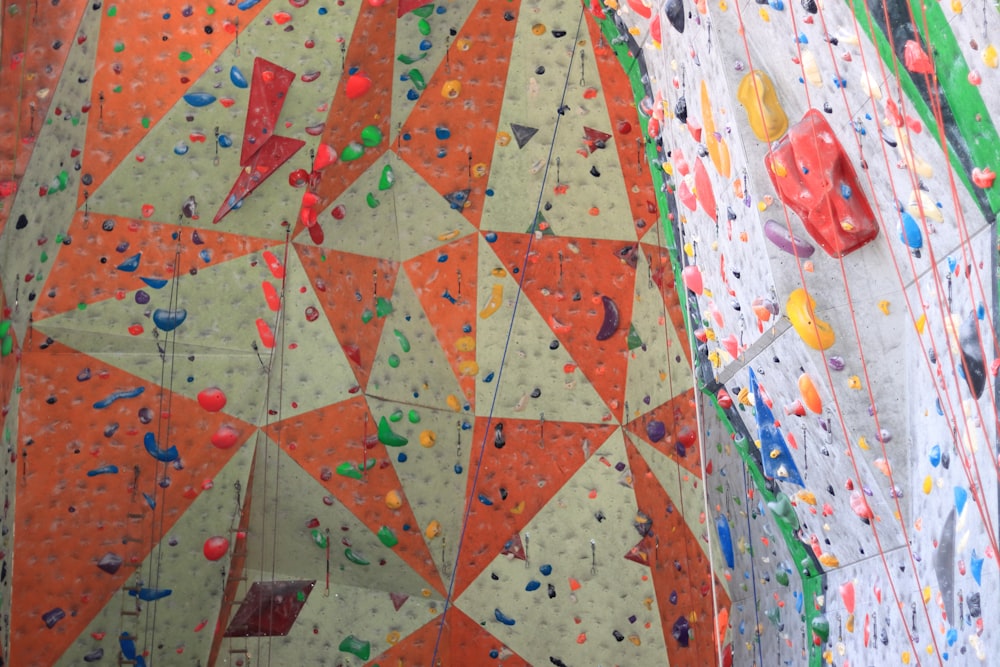 a man climbing on a climbing wall in a gym