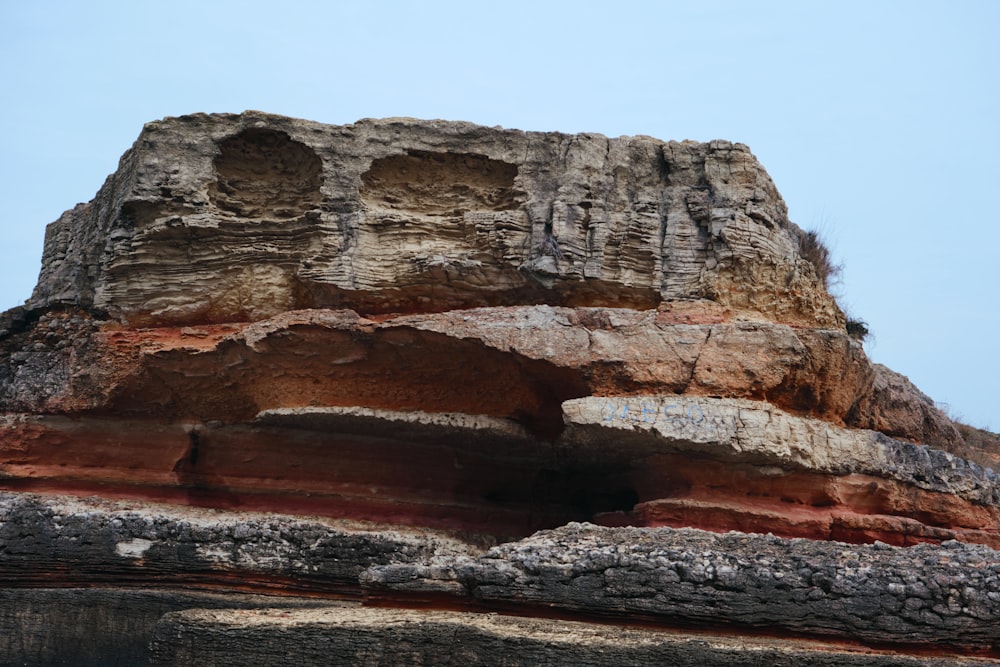 a rock formation with a bird perched on top of it