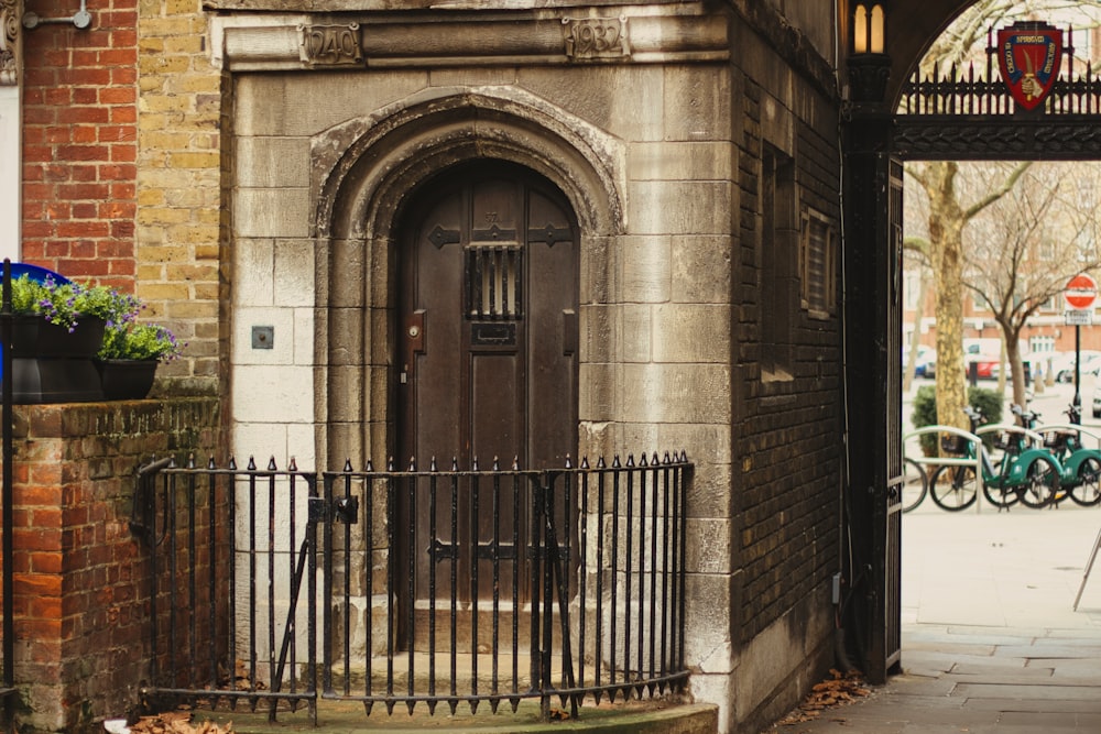 a gated entrance to a building with bicycles parked in the background