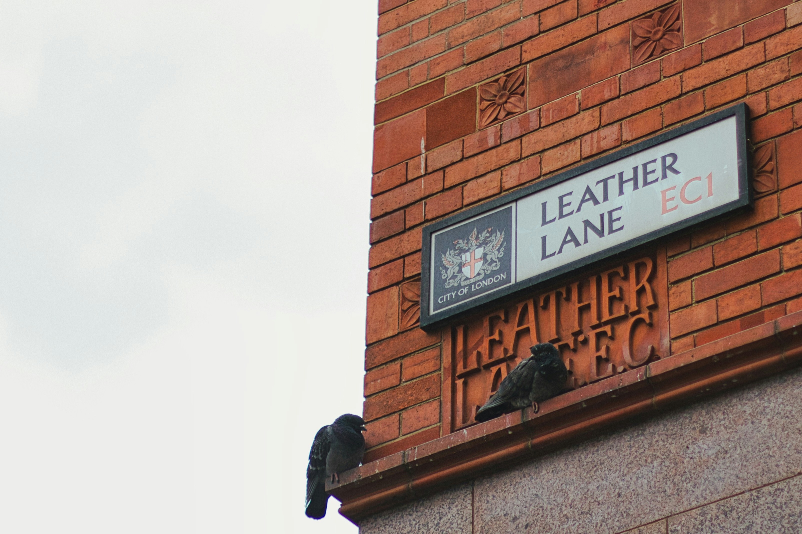 a brick building with a sign on the side of it