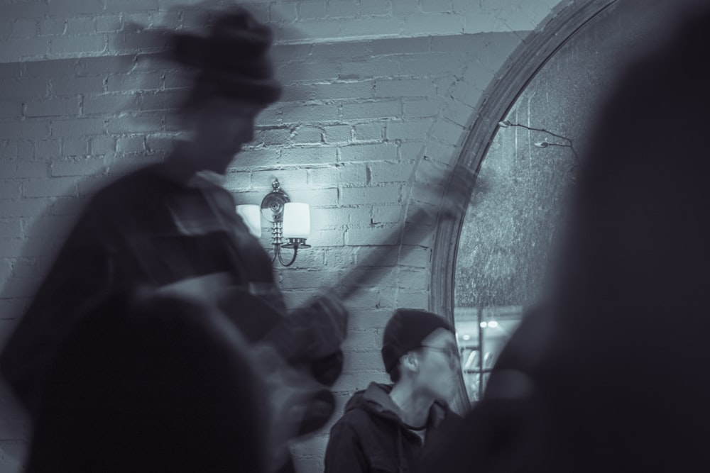 a man standing in front of a mirror holding a guitar