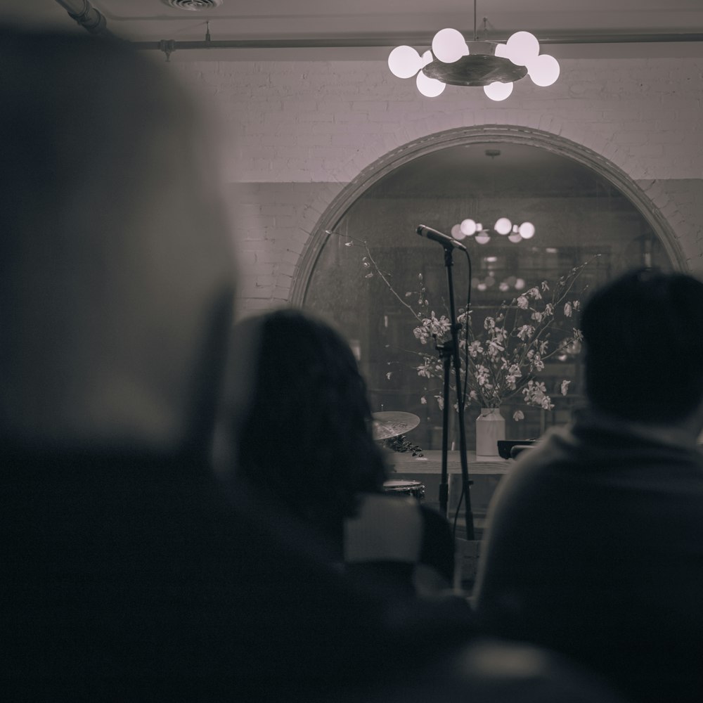 a group of people sitting in front of a microphone