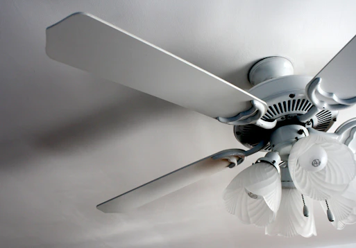 a white ceiling fan in a white room