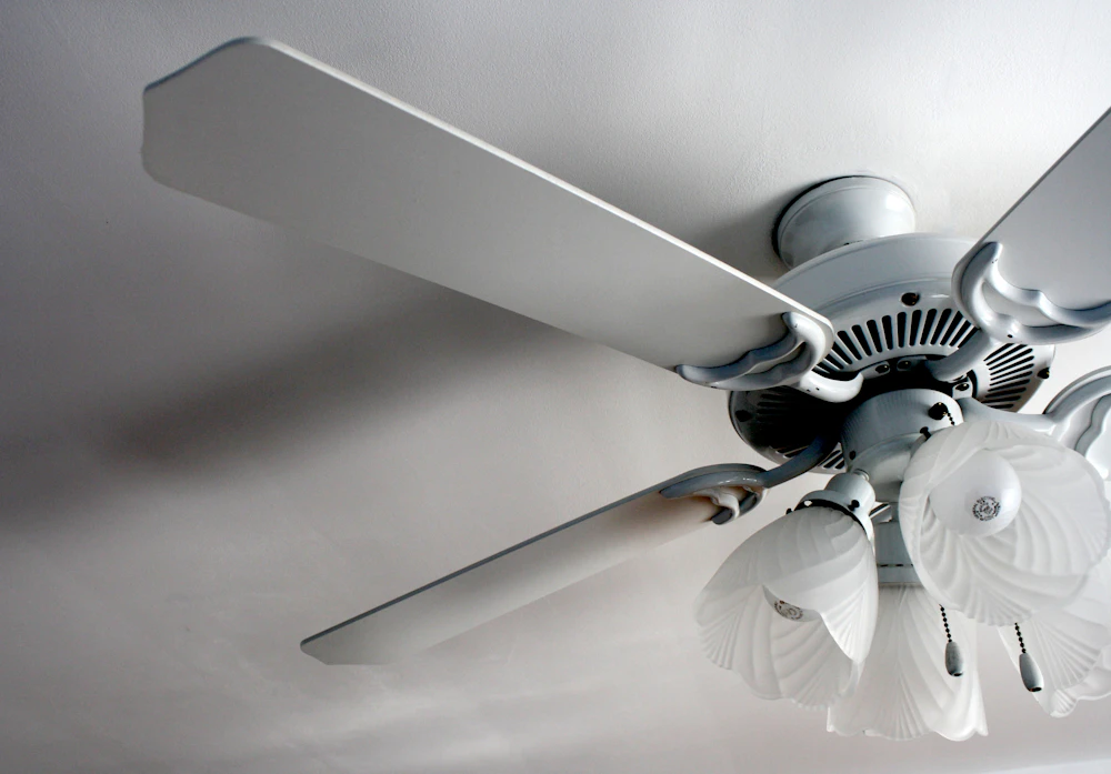 White ceiling fan in a white room