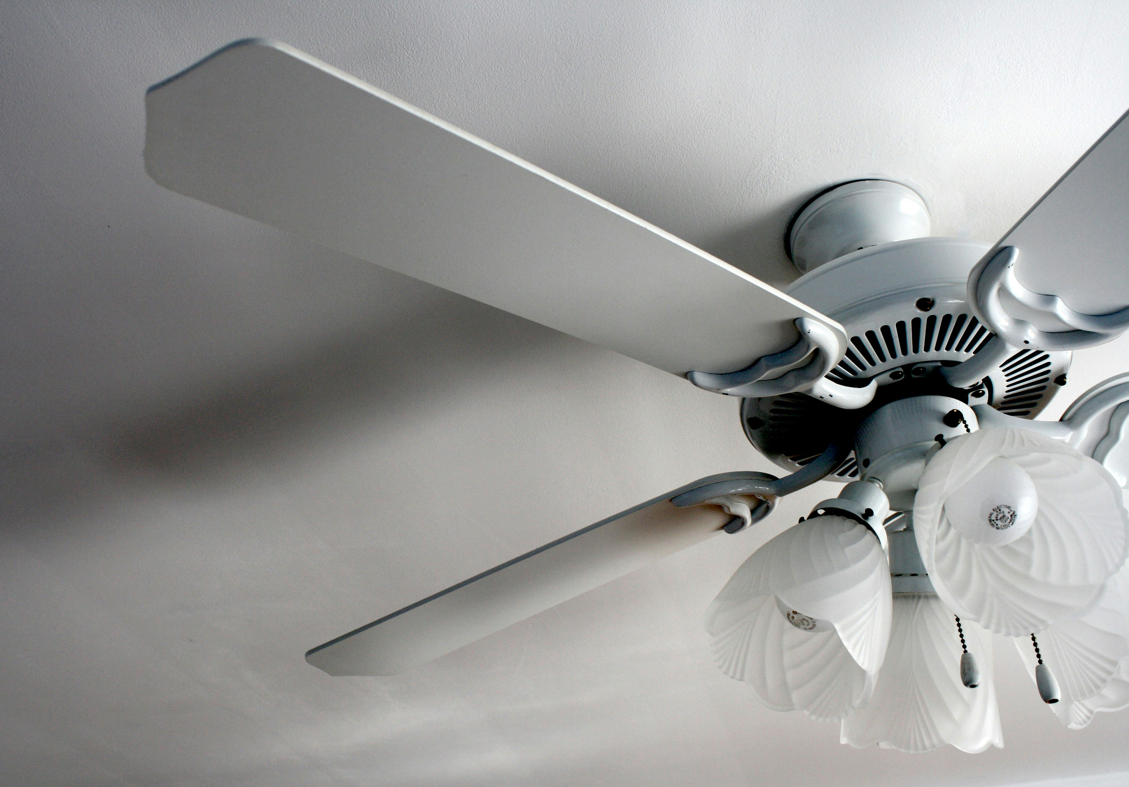 a white ceiling fan in a white room