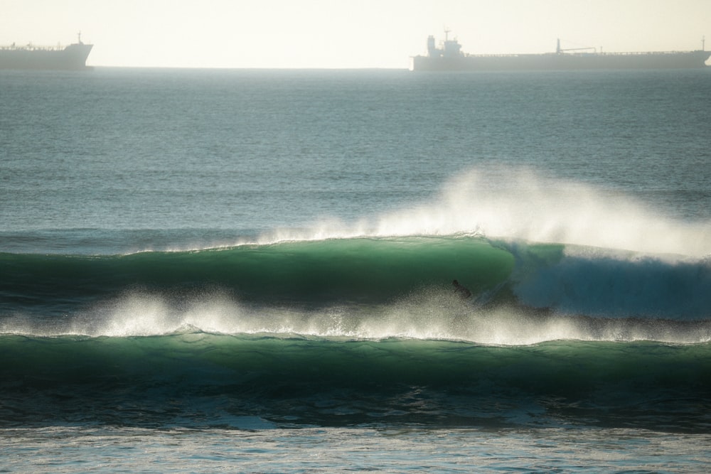 a person riding a wave on top of a surfboard