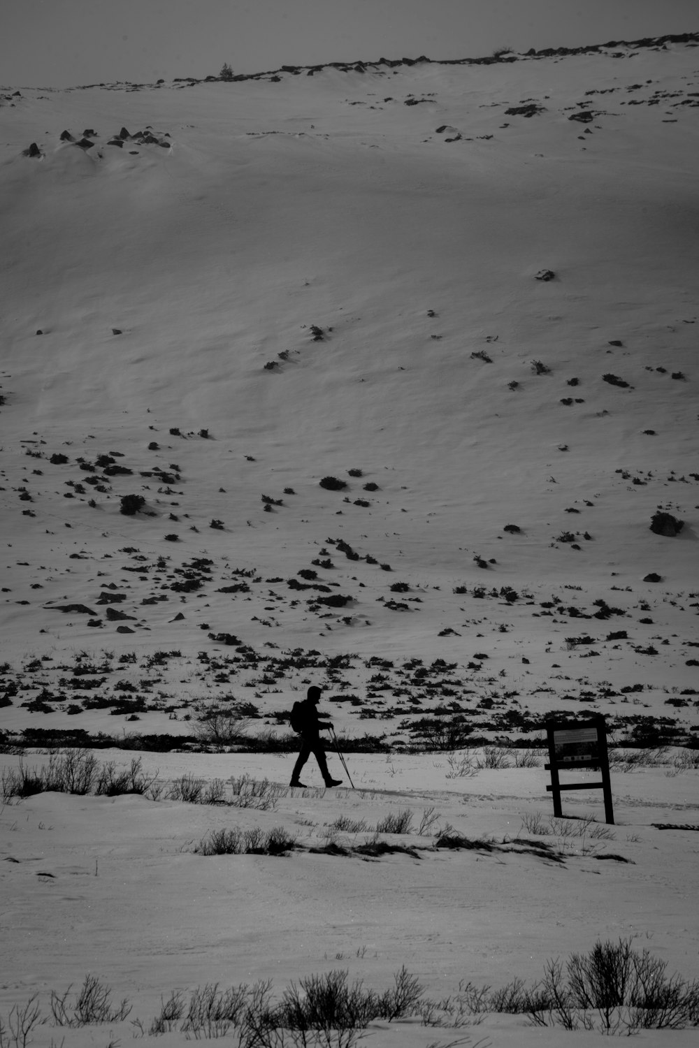 a person walking across a snow covered field