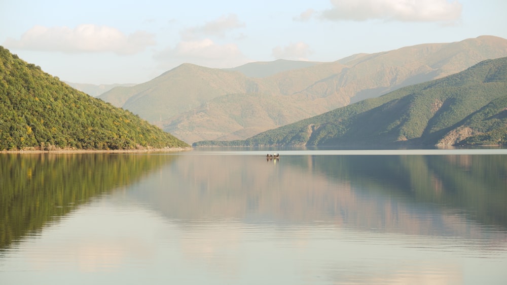 a lake with mountains in the background