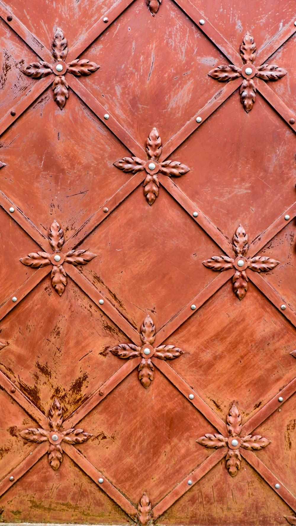 a close up of a metal surface with a clock on it