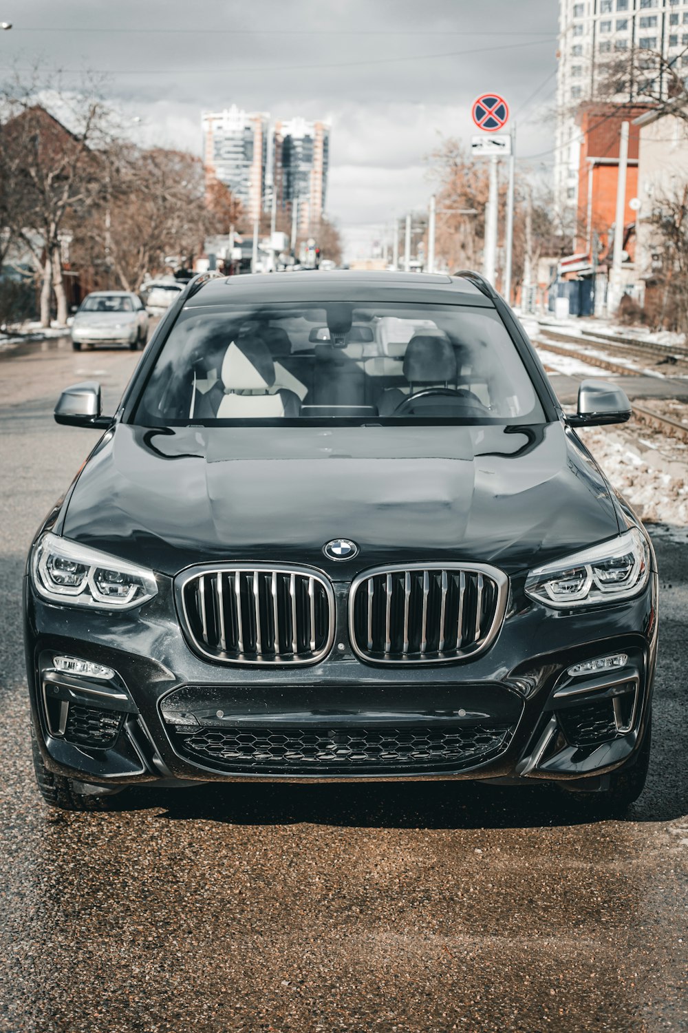 a black car parked on the side of the road