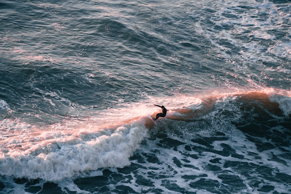 Eine Person, die auf einem Surfbrett auf einer Welle im Meer fährt