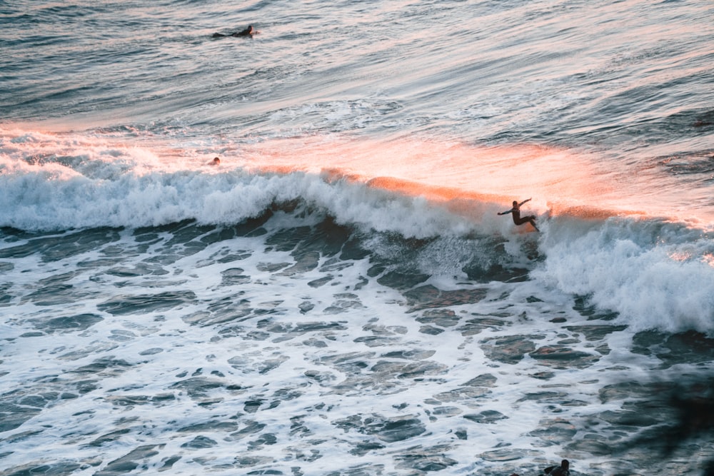 a person riding a surfboard on a wave in the ocean