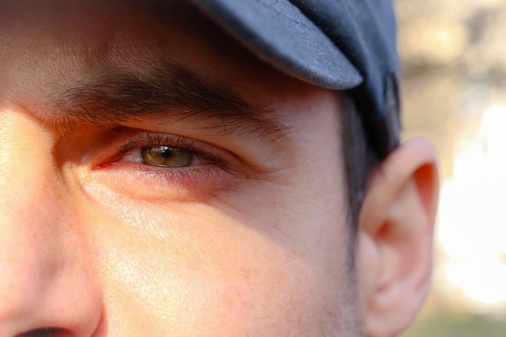 a close up of a person wearing a hat