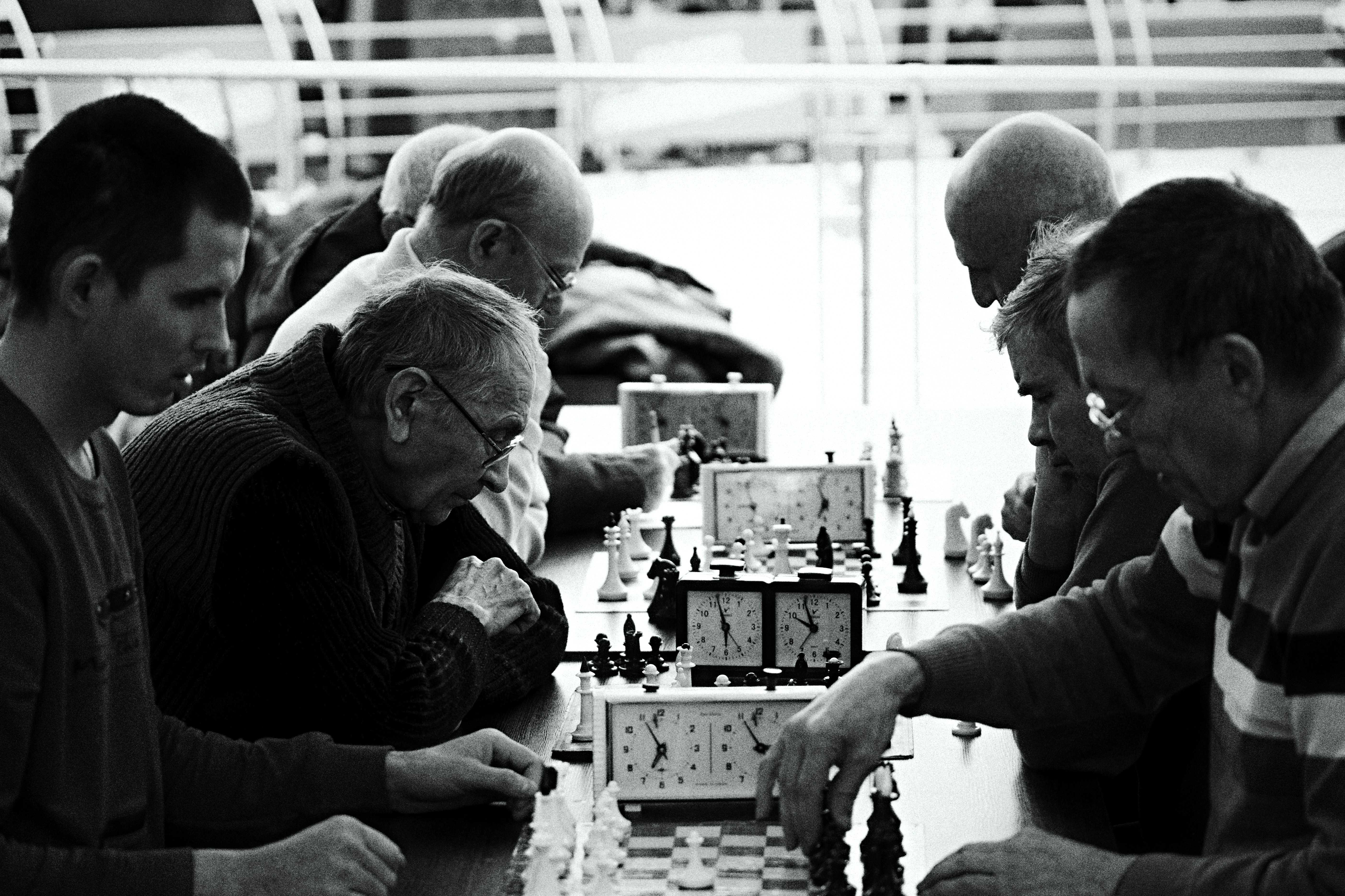 a group of people playing a game of chess