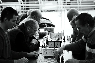 a group of people playing a game of chess