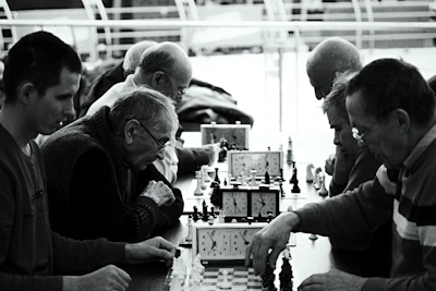 a group of people playing a game of chess