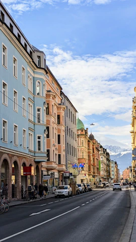 A group of happy tourists exploring the colorful streets of La Paz with mountains in the background.