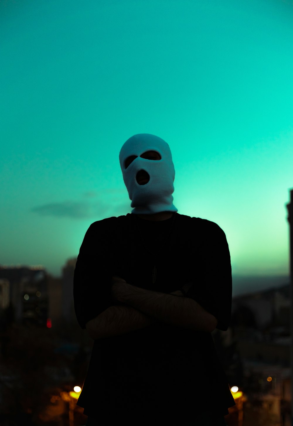 a person wearing a mask standing in front of a building