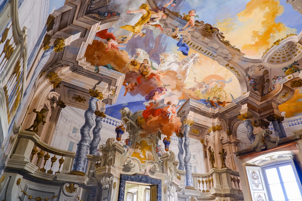 the ceiling of a building with a painting on it