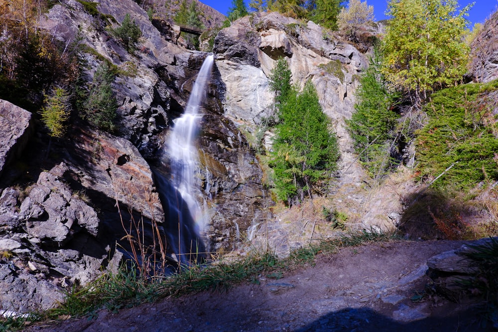 a waterfall in the middle of a rocky area