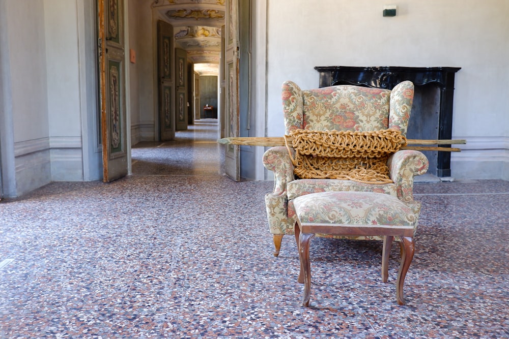 a chair sitting in a hallway next to a fire place