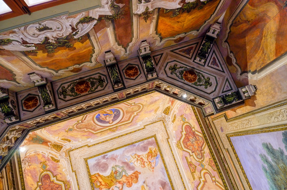 the ceiling of a building with paintings on it