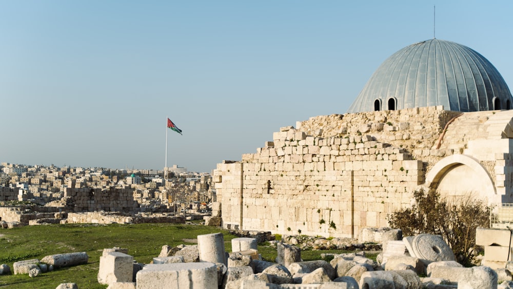 a large stone structure with a flag on top of it