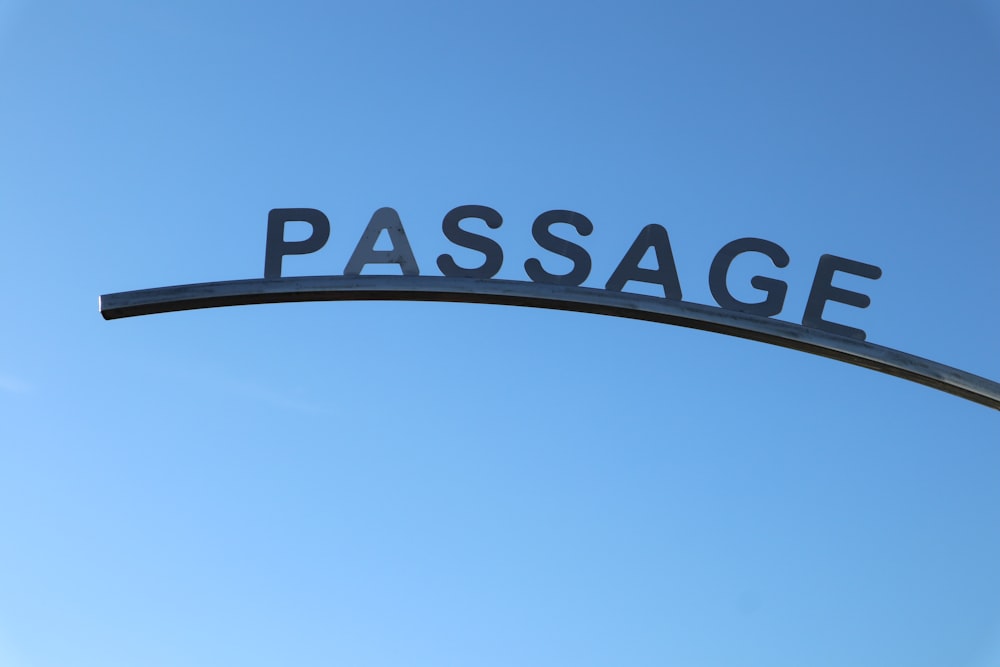a street sign that reads passage under a blue sky