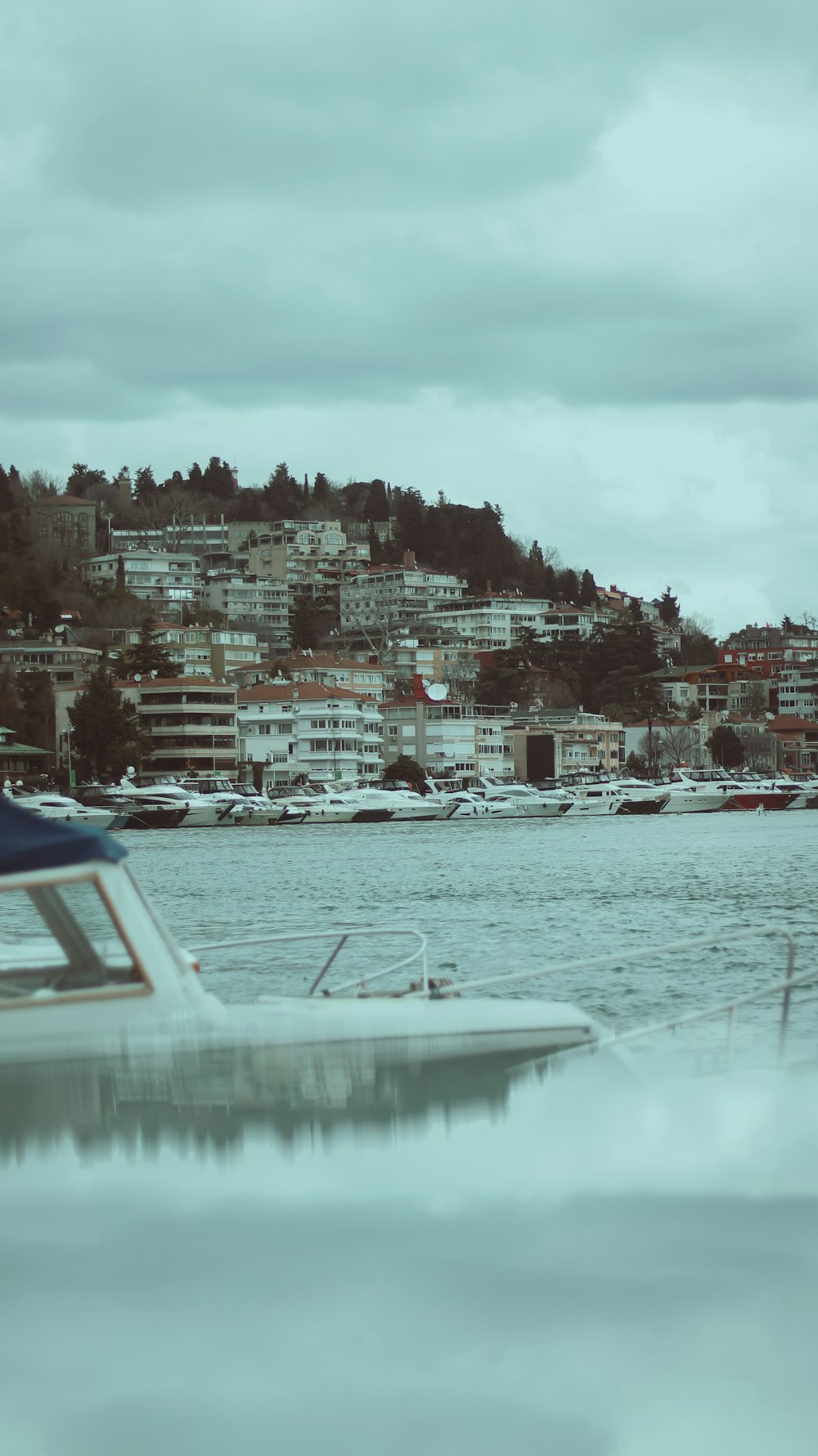 a boat in the water with a city in the background