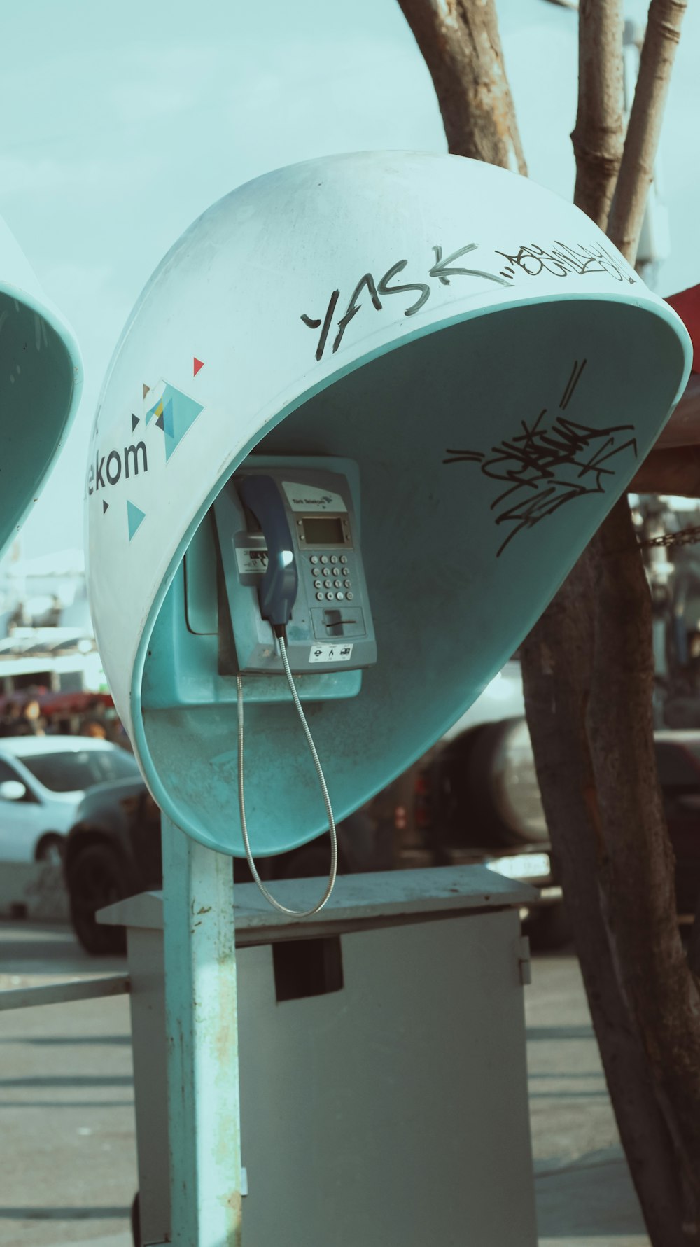 an old fashioned pay phone on a pole