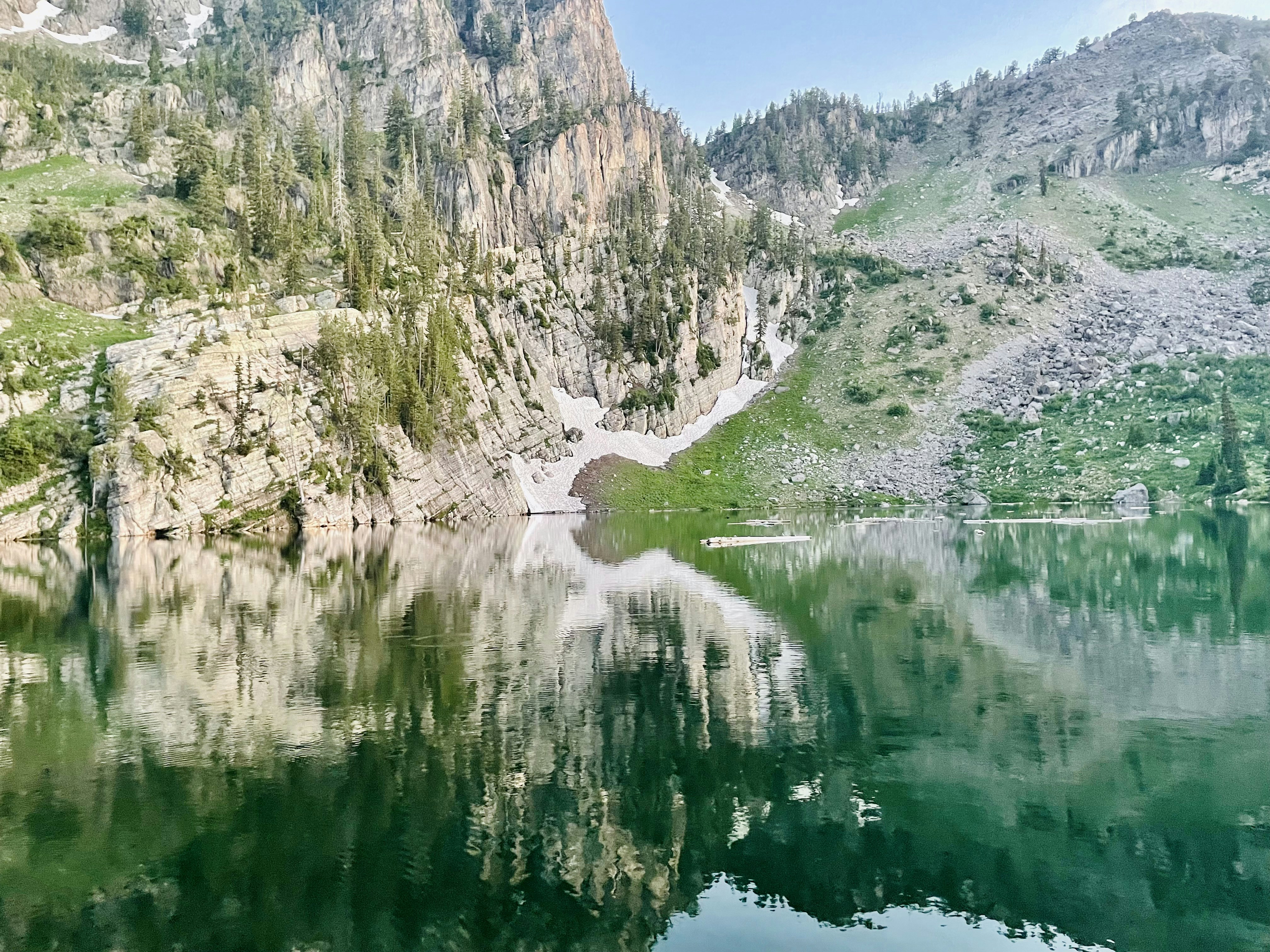 a body of water surrounded by mountains and trees