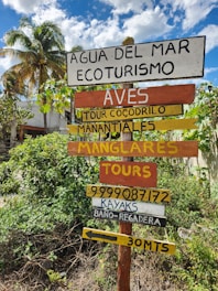 a bunch of signs that are on a pole