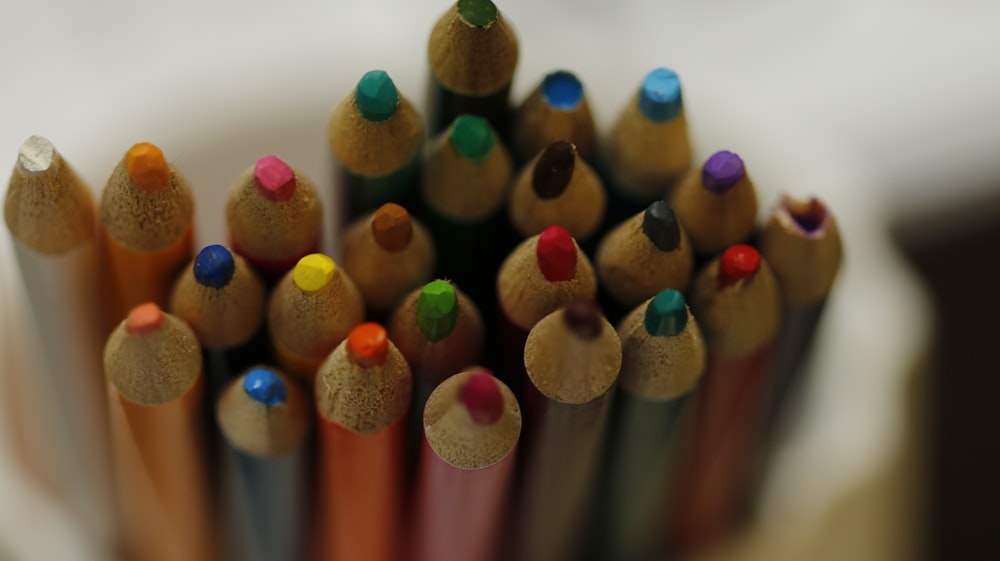 a close up of a group of colored pencils