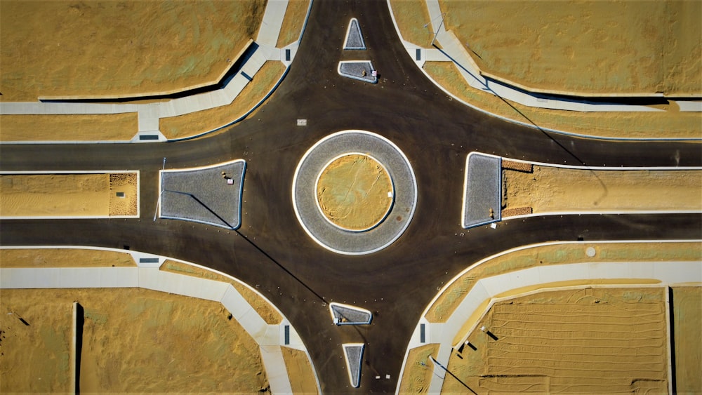 an aerial view of a street intersection with a circle in the middle