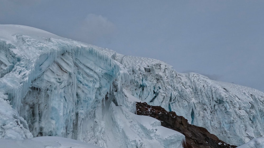 a very tall ice covered mountain side